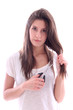 Photo: Young woman with scissors in hand on white background Young woman with scissors in hand on white background