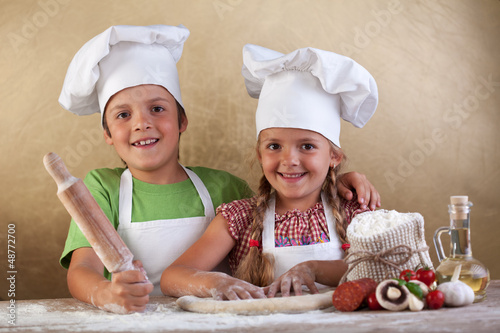 Photo: Happy kids making pizza togheter Happy kids making pizza togheter