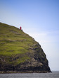 Red lighthouse on a cliff