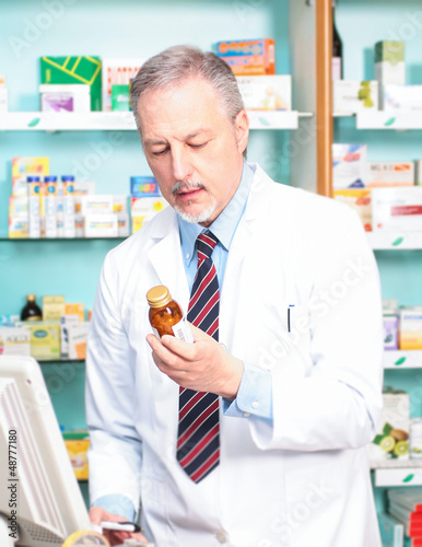 Photo: Man at work in a pharmacy Man at work in a pharmacy