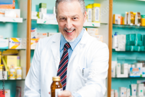 Photo: Man at work in a pharmacy Man at work in a pharmacy