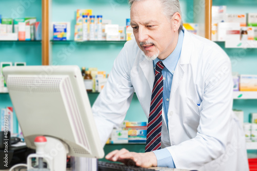 Photo: Man at work in a pharmacy Man at work in a pharmacy