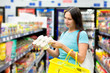 A woman buys tinned meat