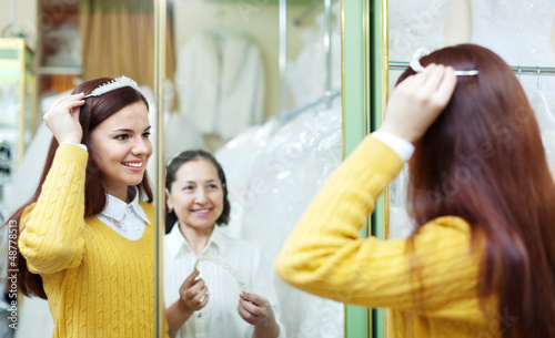 Photo: bride chooses bridal accessories at shop bride chooses bridal accessories at shop