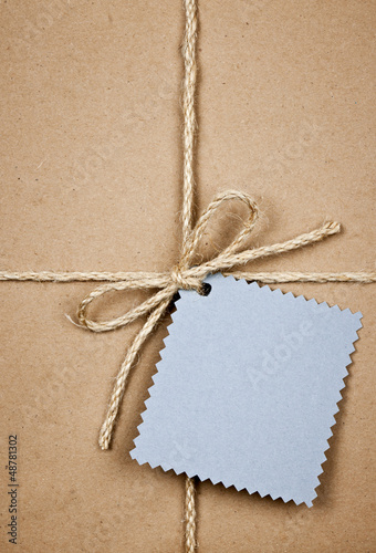 Photo: Gift with blue card in brown paper Gift with blue card in brown paper