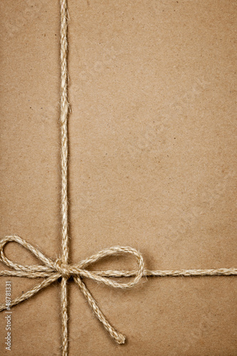 Photo: Package in brown paper tied with string Package in brown paper tied with string