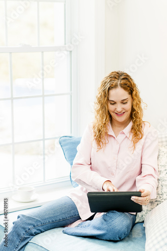 Photo: Woman with tablet computer at home Woman with tablet computer at home