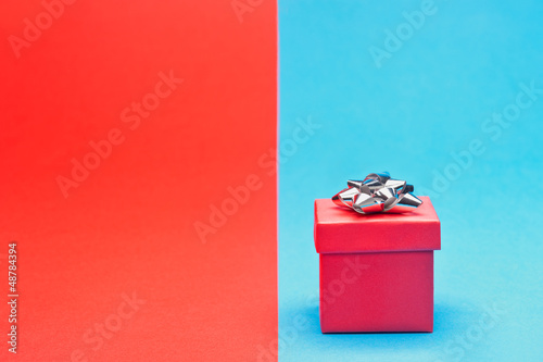 Photo: Red present with silver bow Red present with silver bow