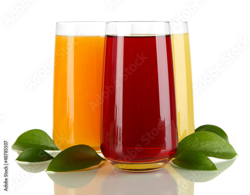 Photo: Glasses of juise and leafs isolated on white Glasses of juise and leafs isolated on white