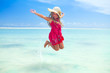 girl jumping in tropical sea