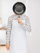 man with pan at kitchen