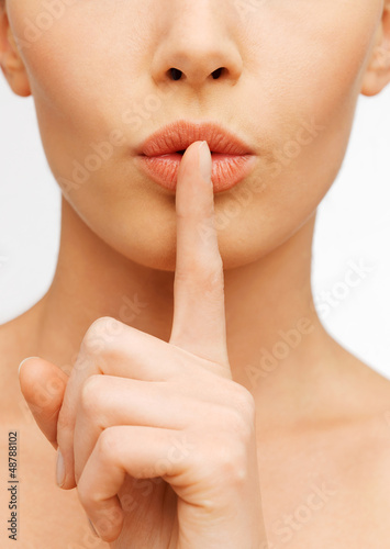 Photo: woman making a hush gesture woman making a hush gesture