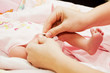 Photo: Mother dresses her baby Mother dresses her baby