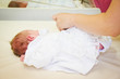 Photo: Mother dresses her baby Mother dresses her baby