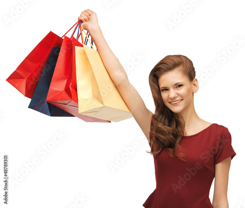Photo: teenage girl in red dress with shopping bags teenage girl in red dress with shopping bags