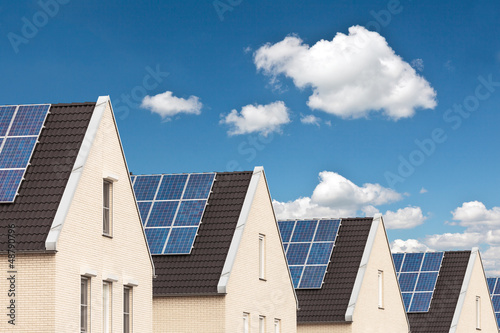 Photo: Row of new houses with solar panels Row of new houses with solar panels