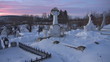 Young woman walking in cemetery during winter time