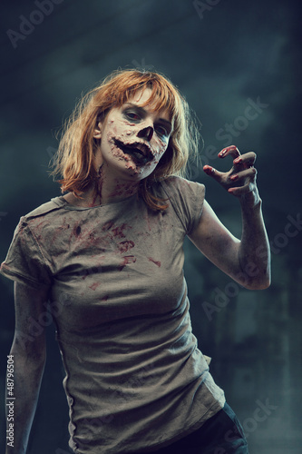 Photo: Creepy zombie over apocalyptic background Creepy zombie over apocalyptic background
