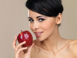 Beautiful brunette with a red apple