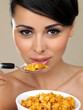 Beautiful woman eating cereal