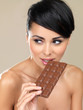 Beautiful woman with a bar of chocolate