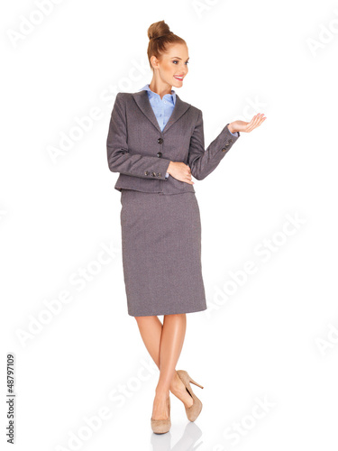 Photo: Stylish businesswoman holding out her palm Stylish businesswoman holding out her palm