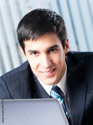 Photo: Businessman working with laptop Businessman working with laptop