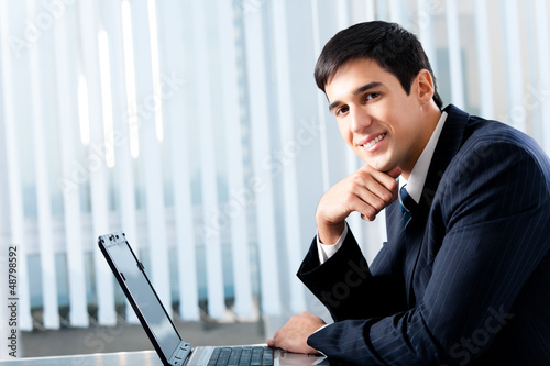 Photo: Businessman working with laptop Businessman working with laptop