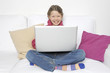 Kind mit Laptop lacht in die Kamera