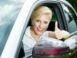 Photo: Beautiful woman shows thumbs up in her new car Beautiful woman shows thumbs up in her new car
