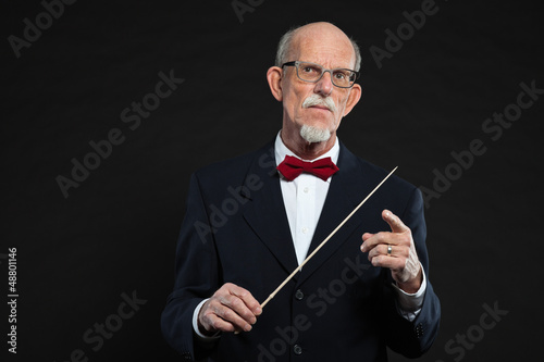 Photo: Senior conductor wearing suit. Studio shot. Senior conductor wearing suit. Studio shot.