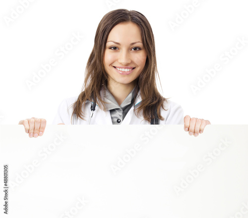 Photo: Happy doctor showing signboard, over white Happy doctor showing signboard, over white