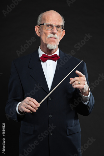 Photo: Senior conductor wearing suit. Studio shot. Senior conductor wearing suit. Studio shot.