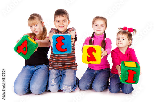 Photo: Happy kids holding blocks with numbers Happy kids holding blocks with numbers