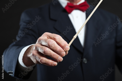 Photo: Conductor conducting an orchestra isolated. Conductor conducting an orchestra isolated.