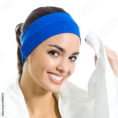 Photo: Cheerful woman in fitness wear with towel, over white Cheerful woman in fitness wear with towel, over white