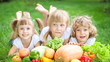 Group of happy children having picnic outdoors