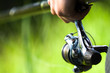 Fisherman holding rod (reel) Catch trench, crucian, bremes etc