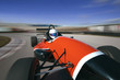 red racing car driving at high speed in circuit.Camera on board