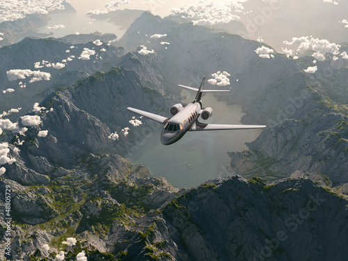 Photo: aircraft flies over a mountain range aircraft flies over a mountain range