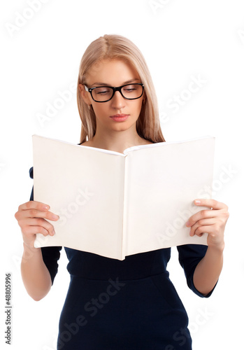 Photo: Young woman reading womens magazine Young woman reading womens magazine