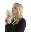Successful young businesswoman blowing a kiss to euro notes
