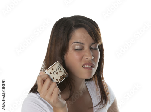 Photo: Woman dislikes a cup of espresso Woman dislikes a cup of espresso