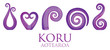 A set of purple glass Maori Koru curl ornaments.