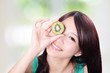 woman holding kiwi fruit cover her eyes