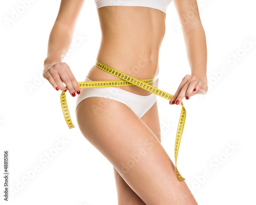 Photo: Athletic girl measuring figure meter Athletic girl measuring figure meter