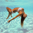 Photo: Girl portrait posing underwater with white bikini. Girl portrait posing underwater with white bikini.