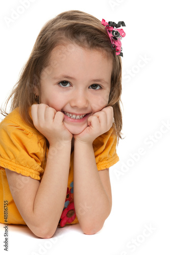 Photo: Smiling little girl in a yellow shirt Smiling little girl in a yellow shirt