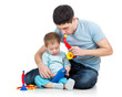 Father and baby boy having fun with musical toys. Isolated on wh
