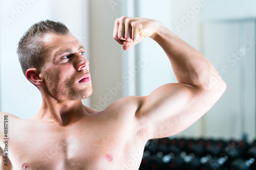 Photo: Bodybuilder posing in Gym Bodybuilder posing in Gym